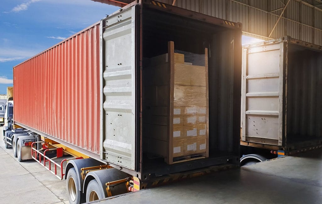 Shipping Container being loaded by International movers