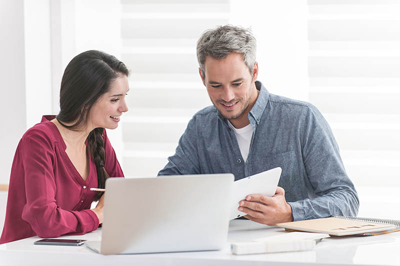 Smiling couple selecting the right quotation