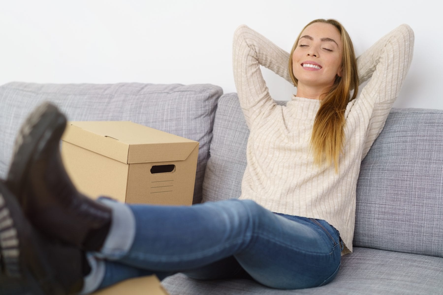 Shortlisting an International Mover - relaxed woman sitting on a couch