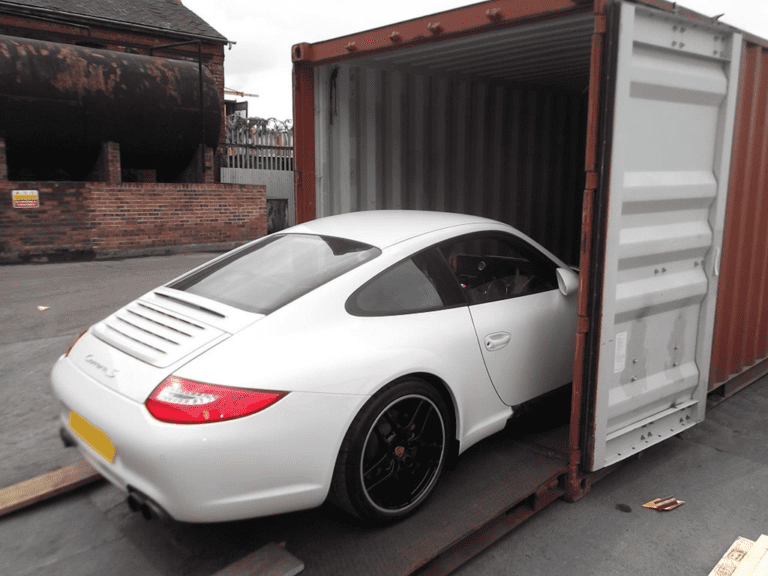 Shipping your car overseas - White sports car being loaded into container