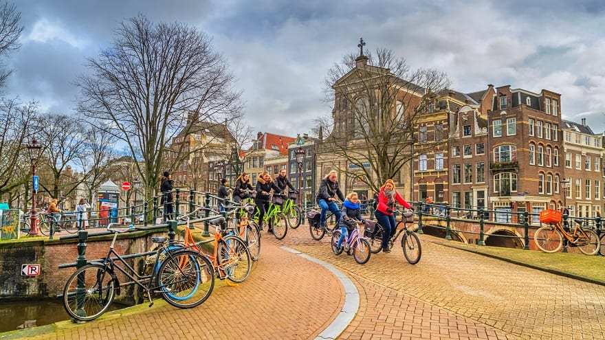 A group of cyclists in the historic center of Amsterdam, The Netherlands