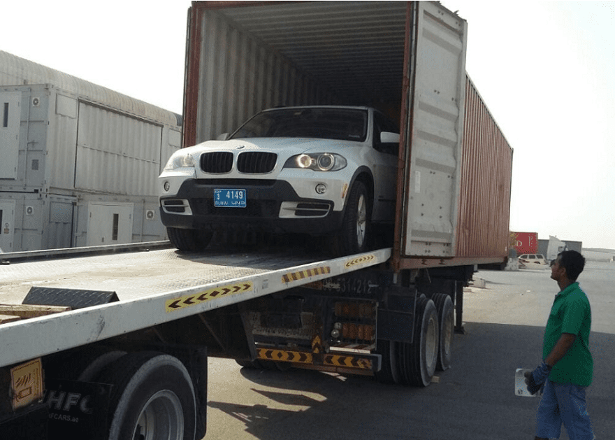 Loading -car-in-shipping-container. Shipping a car home.