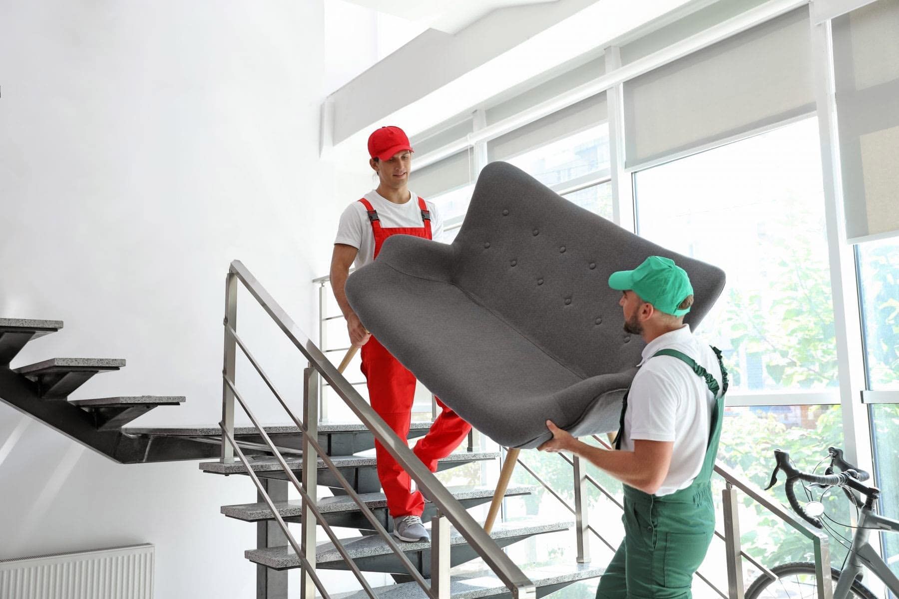 Packers and Movers Carrying Sofa down staircase